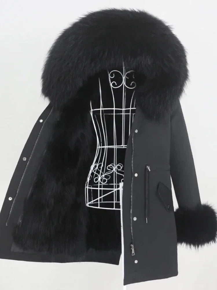 Black coat with fur trim on a mannequin against a white background