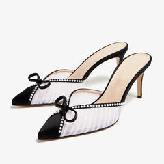 White mesh stiletto pumps with pearl trim and a bow