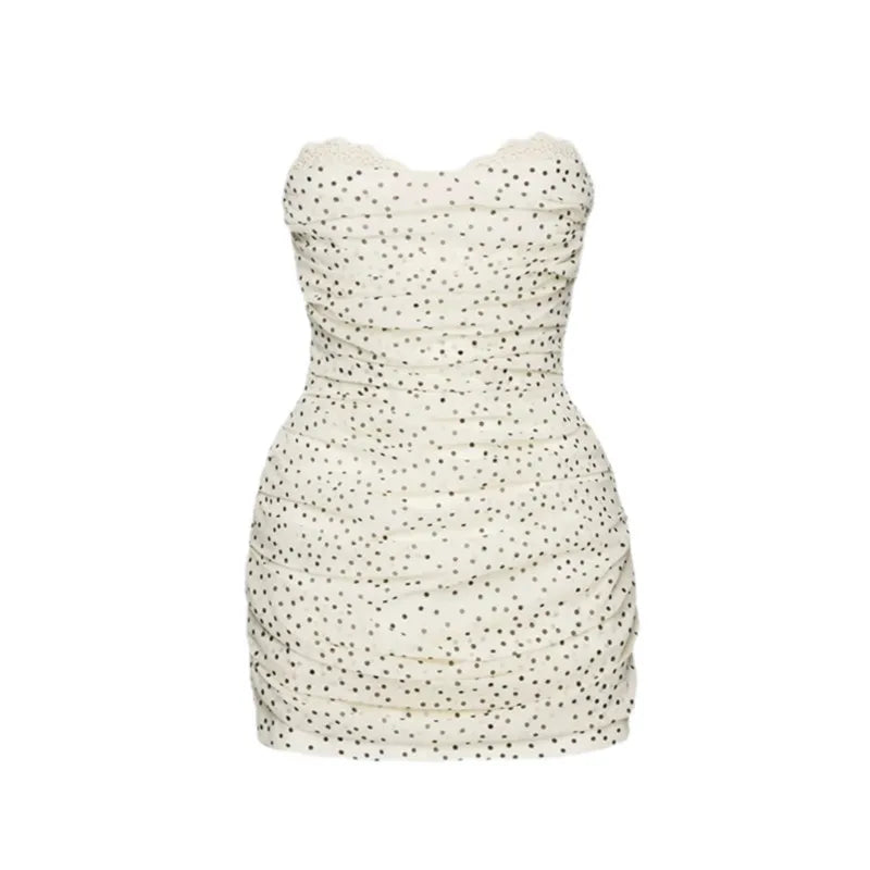 White strapless dress with black polka dot pattern on a white background