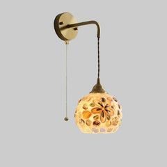 Wall-mounted lamp with floral glass shade on a white background