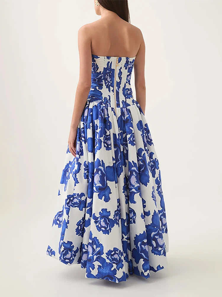 Woman wearing a strapless blue floral dress on a white background