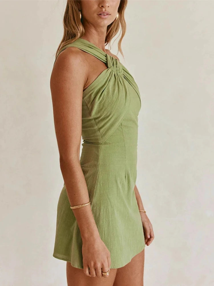 Woman wearing a green dress against a plain background