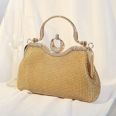 Gold crystal-encrusted clutch bag with ring handle