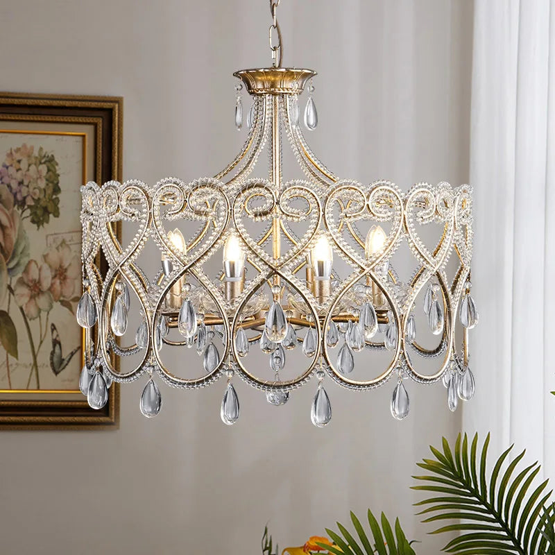 Antique silver crystal chandelier with lace frame and sparkling drops in elegant living space