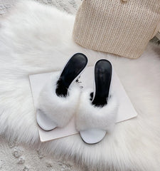 White fur slide heels with white sole and stiletto heel