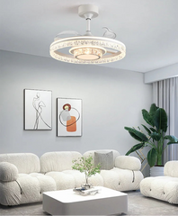 Modern living room with a ceiling light fixture, white sofa, and decorative elements.