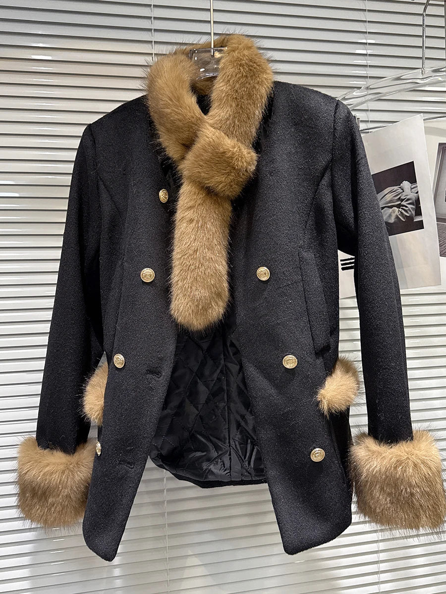 Black coat with fur trim on a hanger against a metallic background