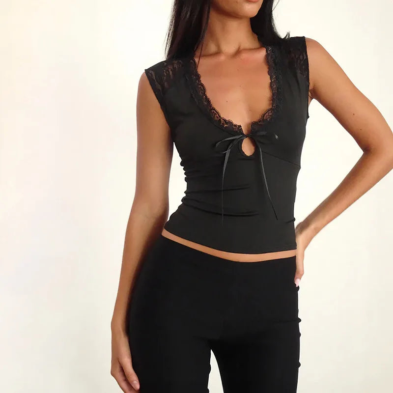 Black sleeveless top with lace details on a plain background