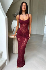 Woman wearing a burgundy lace dress in an indoor setting