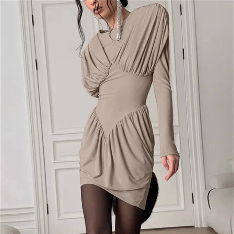Beige long-sleeve dress worn by a person in a neutral setting