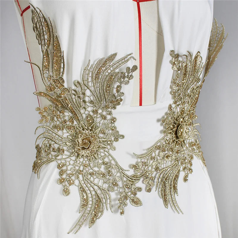 White garment with gold embroidery on a gray background