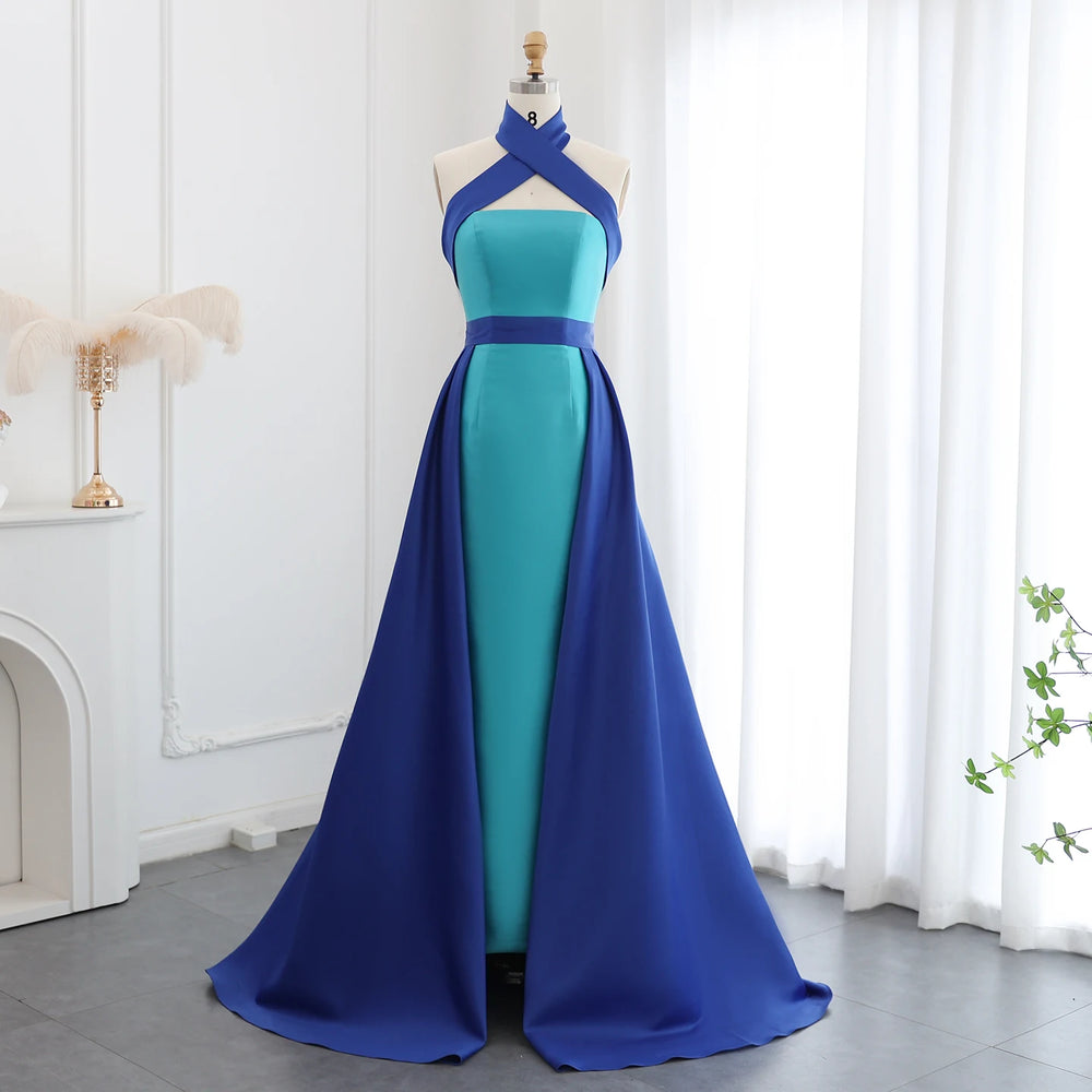 Blue and green evening gown on a mannequin against a white curtain background
