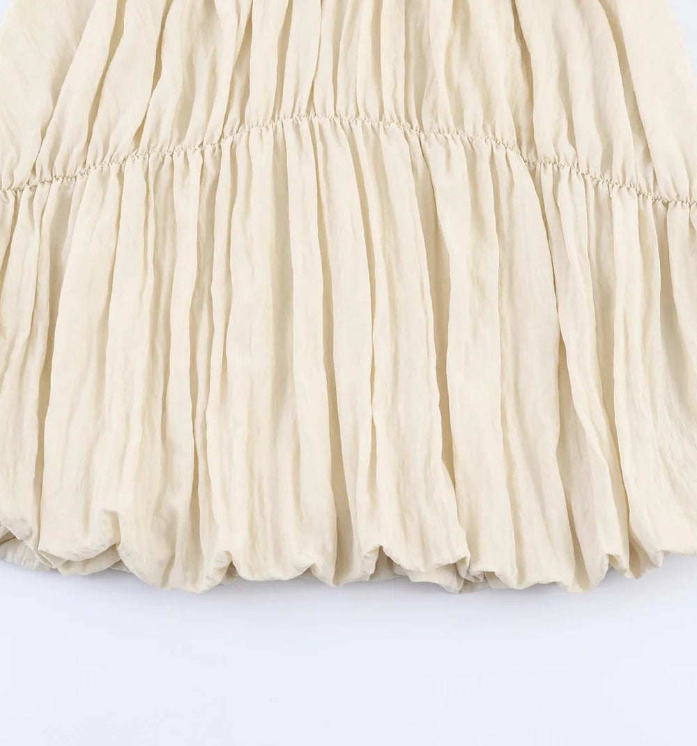 Beige pleated skirt on a white background