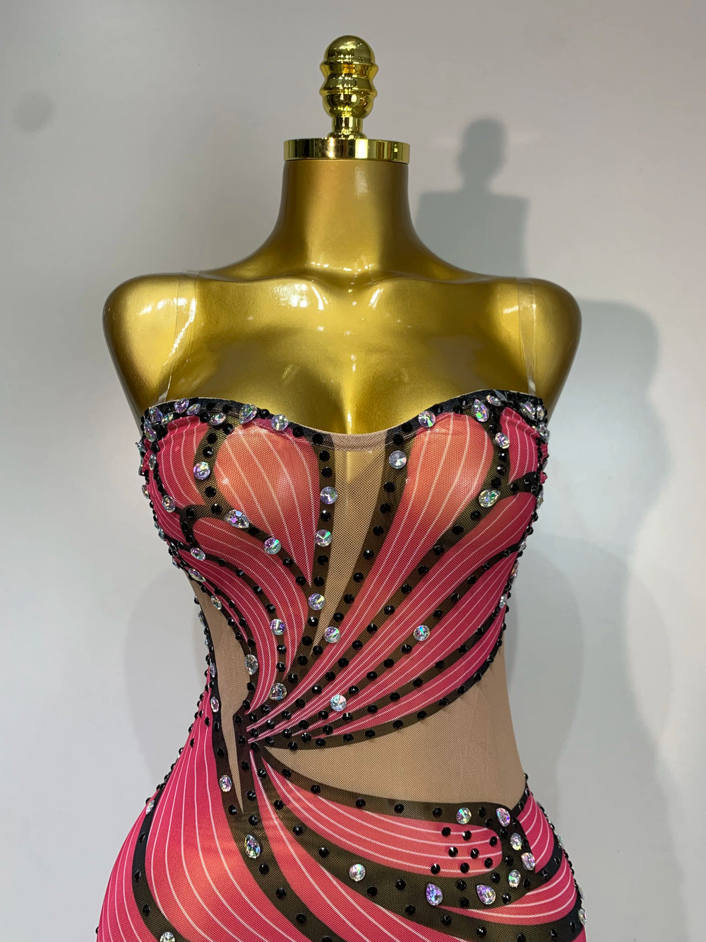Close-up of the bodice on a strapless maxi dress with butterfly print and rhinestone embellishments.