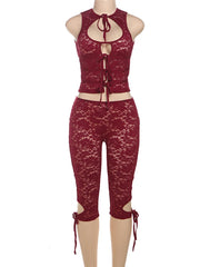 Red lace jumpsuit on a mannequin against a white background