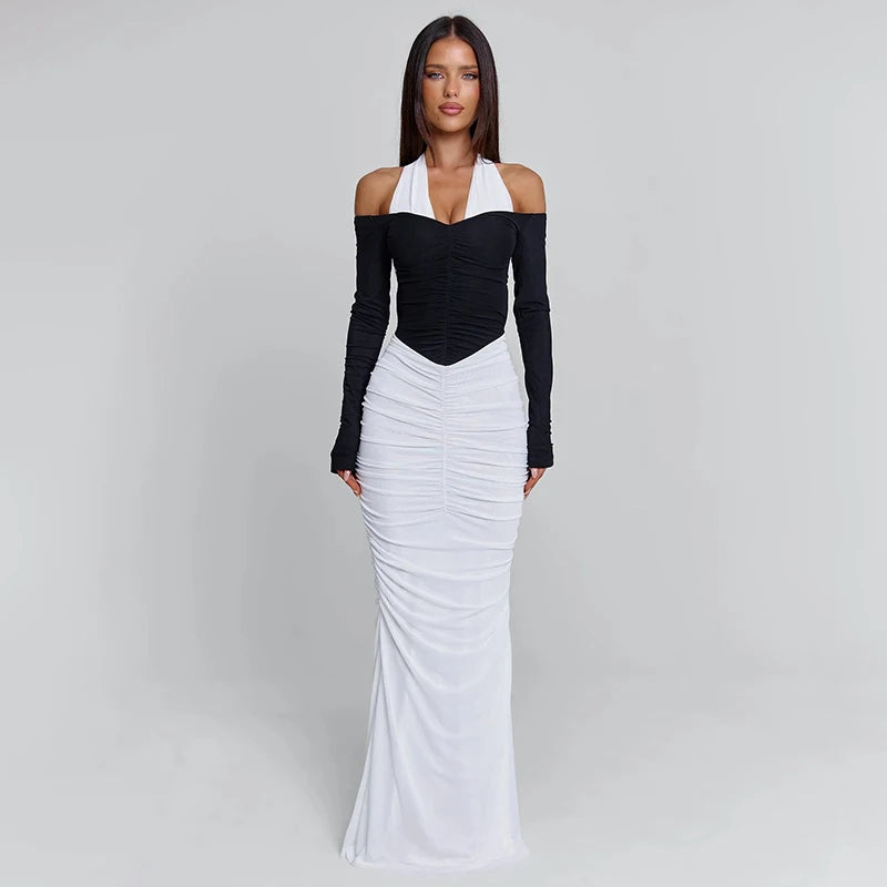 Woman wearing a black and white dress on a gray background