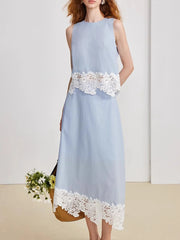 Light blue dress with white lace details on a plain background