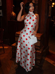 Back view of a polka dot halter neck maxi dress