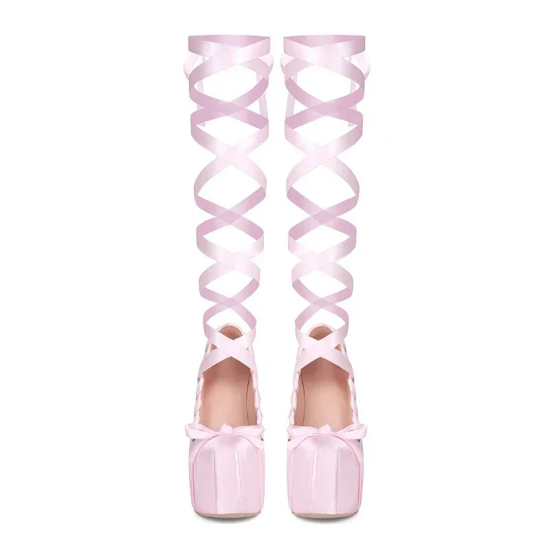 Pink over-the-knee shoes with ribbon design on a white background