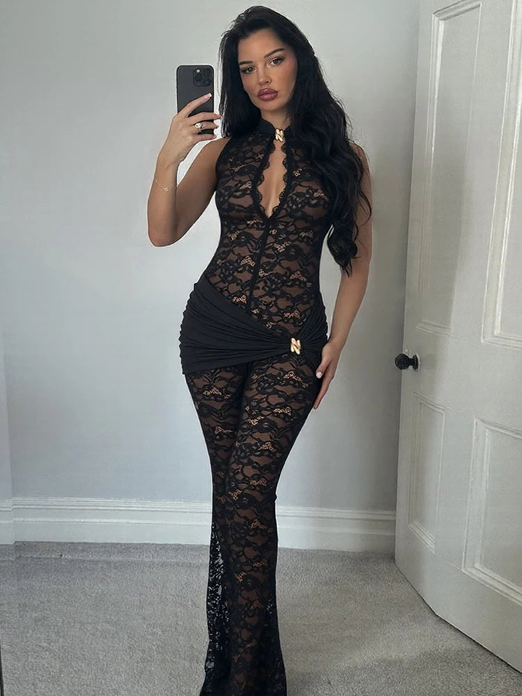 Model wearing a black lace mock neck halter jumpsuit with flared legs.