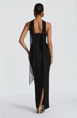 Black dress with sheer overlay on a white background