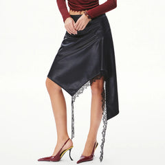 Side view of an asymmetrical faux leather midi skirt with lace hem