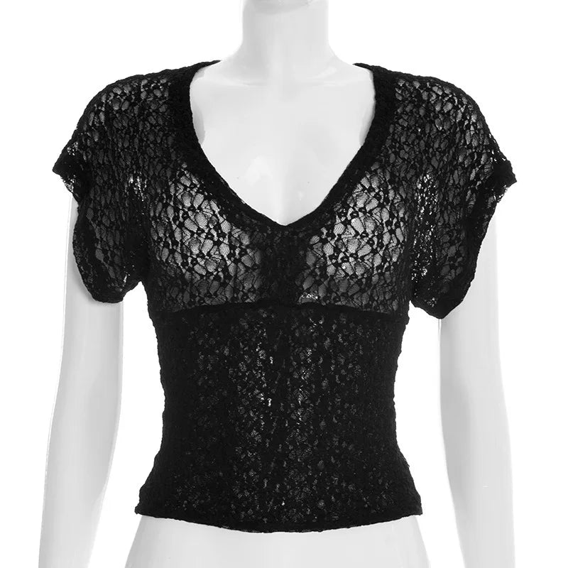 Black lace top on a mannequin against a white background