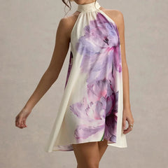 Woman wearing a floral dress with a plain background