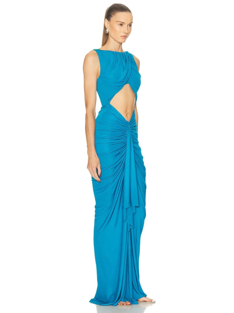 Woman wearing a blue evening gown with cut-out design on a white background