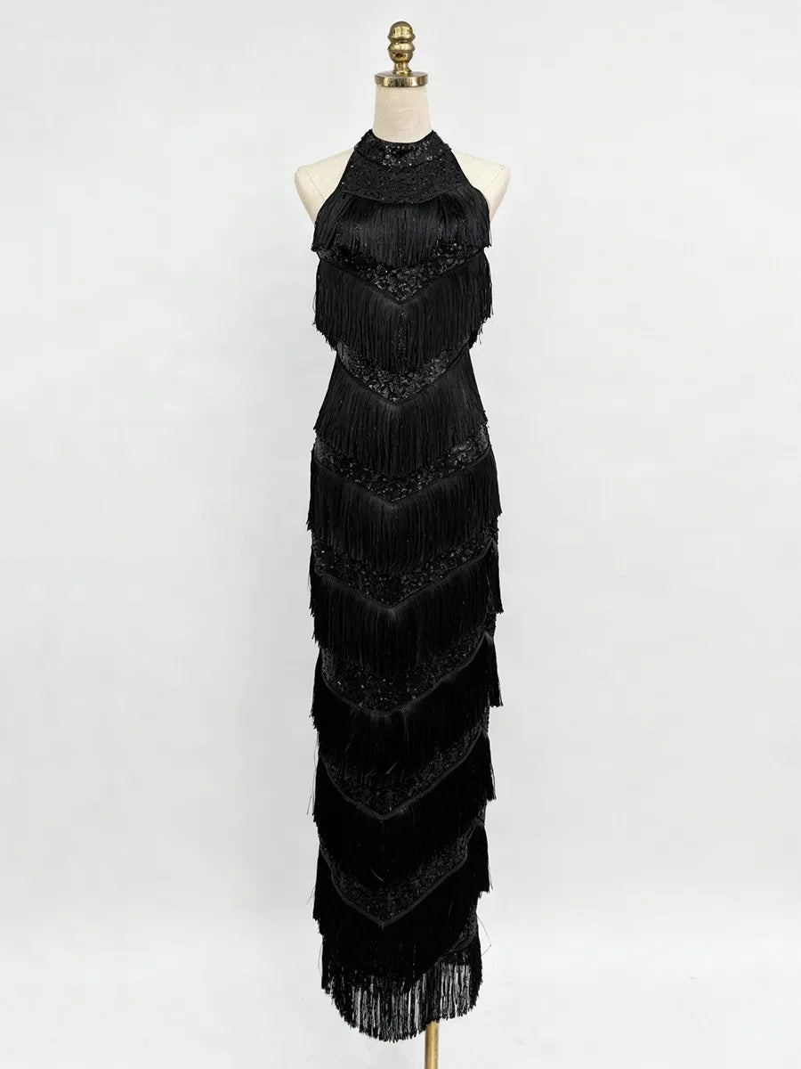 Black fringe dress on a mannequin against a white background