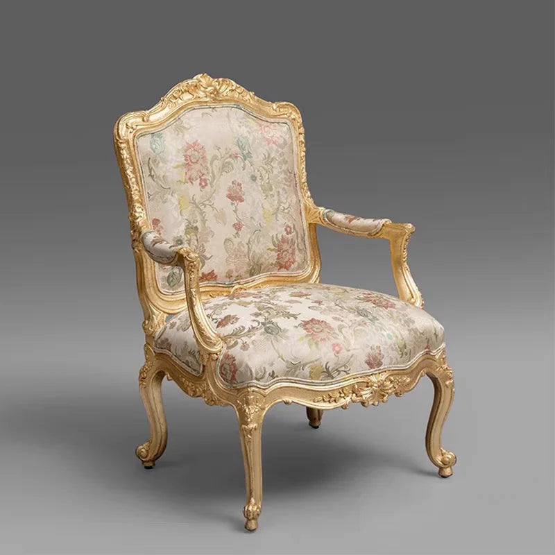 Decorative armchair with floral pattern and gold frame on a gray background