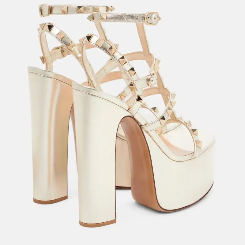 Gold high-heeled platform shoes with clear straps