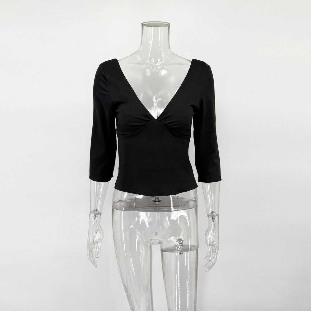 Black V-neck top on a transparent mannequin against a white background