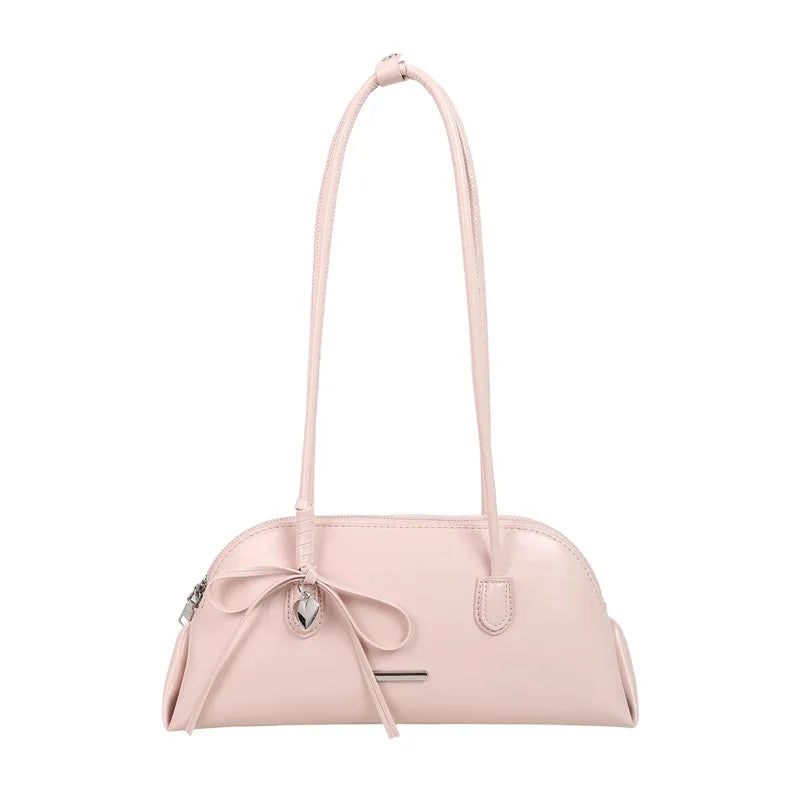 Pale pink patent leather shoulder bag with matching handles and a silver heart charm.