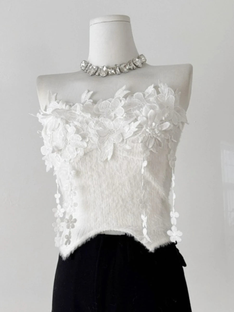 White floral top on a mannequin with a plain background