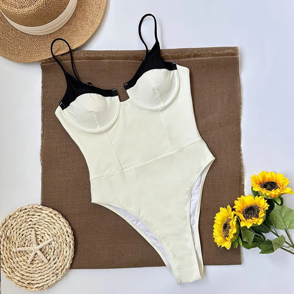 Flat lay of a one piece swimsuit with contrast trim