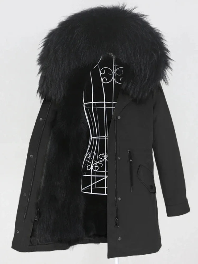 Black parka coat with a large fur hood on a white background