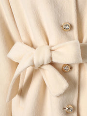 Close-up of beige belted wool blend coat waist and buttons