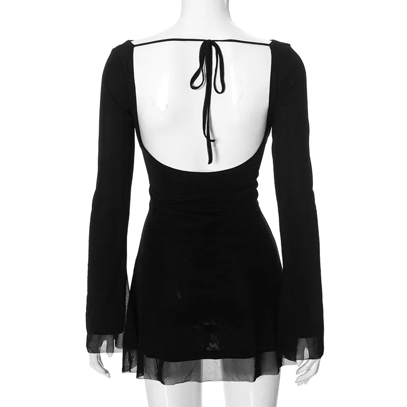 Black dress with sheer overlay and open back on a mannequin