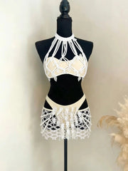 Mannequin displaying embellished mesh skirt and bikini top two-piece set with white macrame details