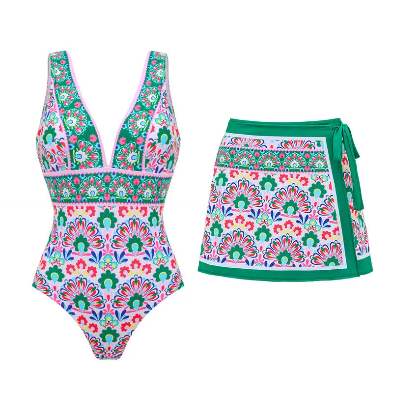 One-piece swimsuit and wrap skirt beachwear set with a vibrant graphic print.