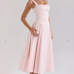 Woman wearing a pink A-line sleeveless cotton midi dress with square neckline, summer fashion