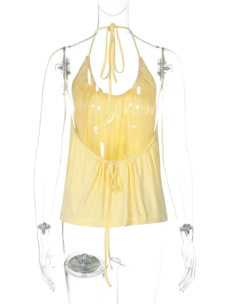 Yellow halter top on a mannequin against a white background