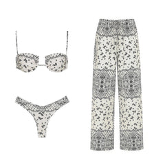 Paisley print bikini top, bikini bottoms, and wide-leg pants arranged flat