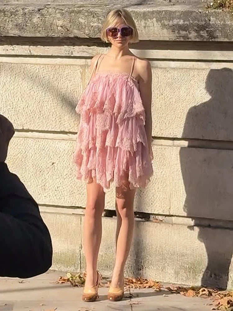 Model wearing a pink lace trim halterneck mini dress outdoors