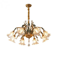 A beautiful French Pastoral crystal chandelier with LED lights, hanging above a dining room table.  Golden Atelier 3