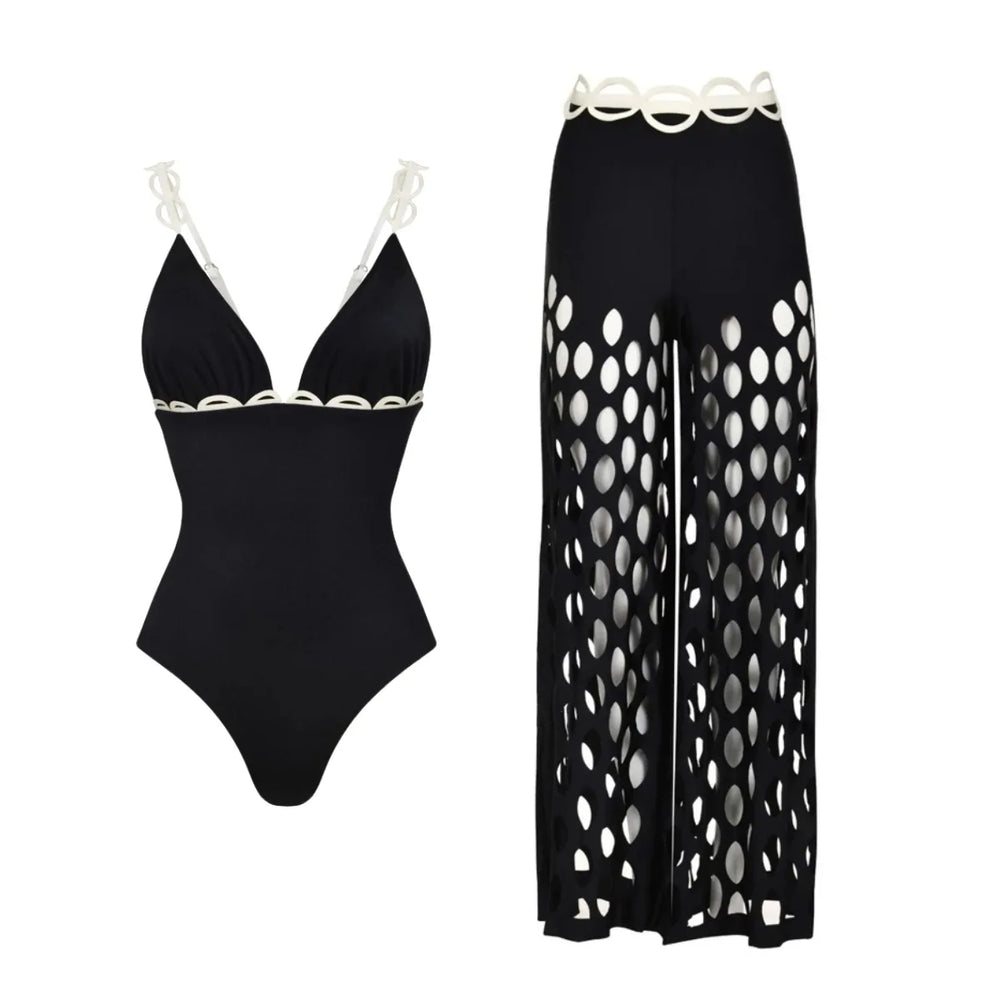 Black one-piece swimsuit with white scalloped trim and matching wide-leg cutout pants.
