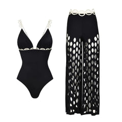 Black one-piece swimsuit with white scalloped trim and matching wide-leg cutout pants.