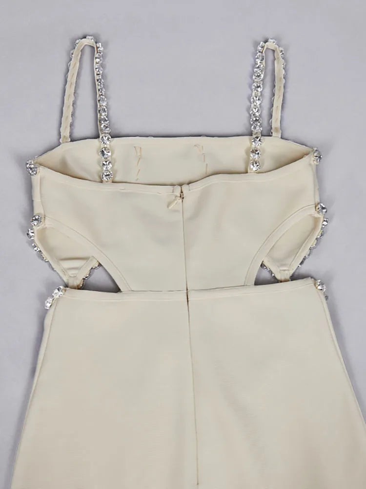 Beige dress with embellished straps on a gray background