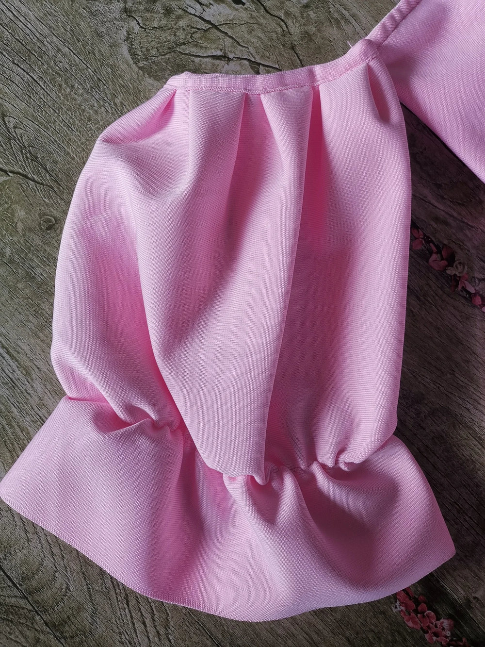 Pink dress on a wooden surface